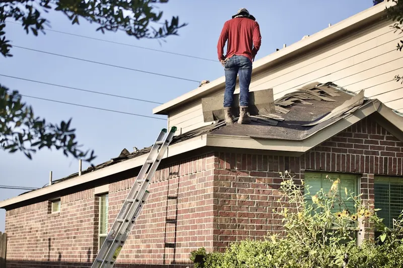 Professional roofer working on a residential roof in Aura